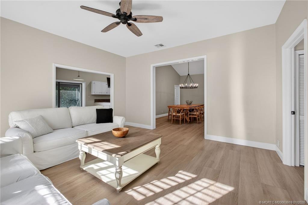 3211 Southeast Court Drive Stuart, FL 34997 - Photo 27 of 60 a living room with furniture and a wooden floor