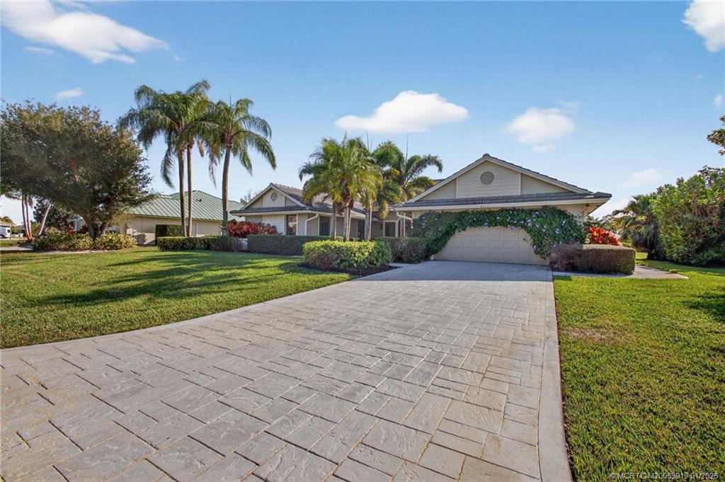 3211 Southeast Court Drive Stuart, FL 34997 - Photo 3 of 60 a front view of a house with a yard