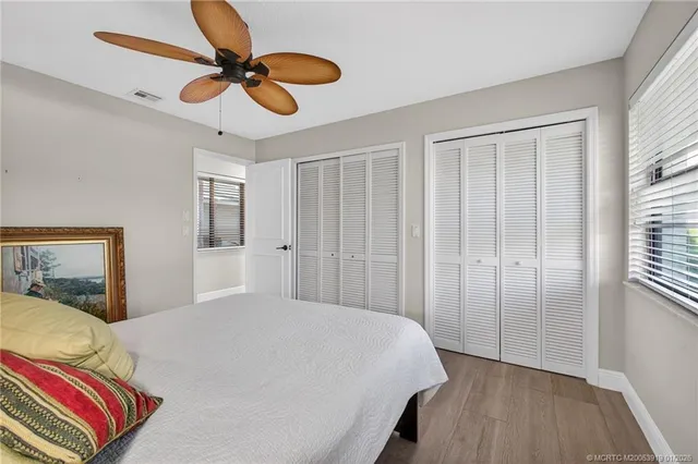 a bedroom with two beds and a chandelier