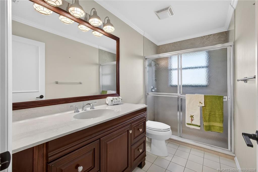 3211 Southeast Court Drive Stuart, FL 34997 - Photo 46 of 60 a bathroom with a sink a toilet a mirror and shower
