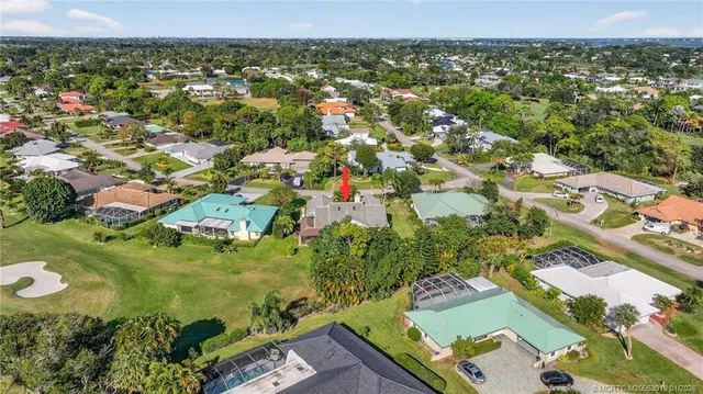 an aerial view of residential houses with outdoor space and swimming pool