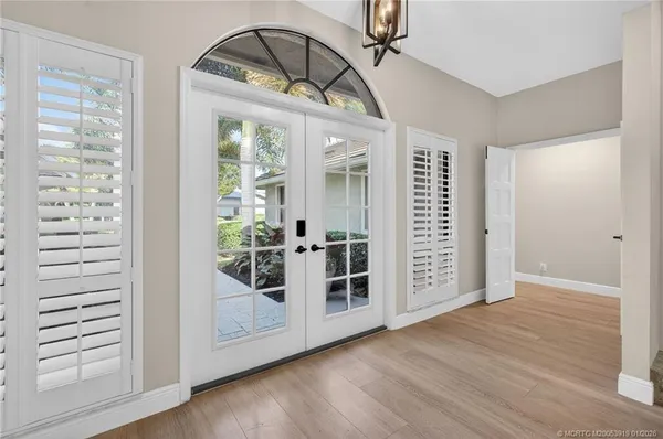 an empty room with wooden floor and a fireplace