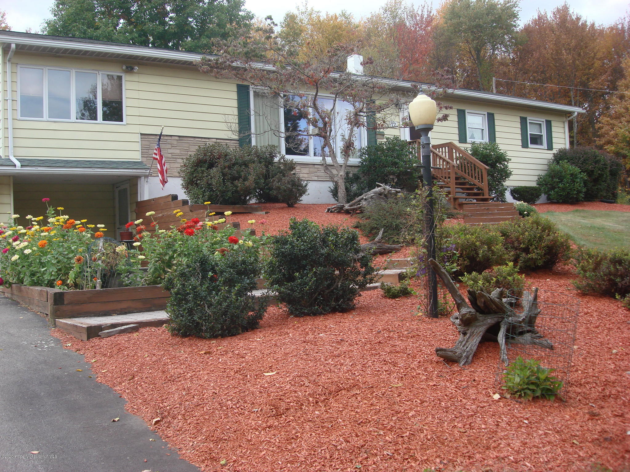 72 Hall Road Laceyville, PA 18623 - Photo 34 of 67 a front view of a house with a yard and garden