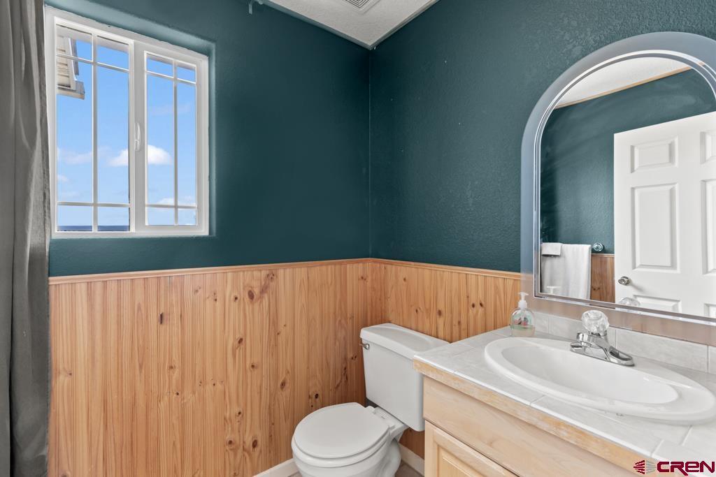 19496 E Road Delta, CO 81416 - Photo 25 of 33 a bathroom with a sink toilet and mirror