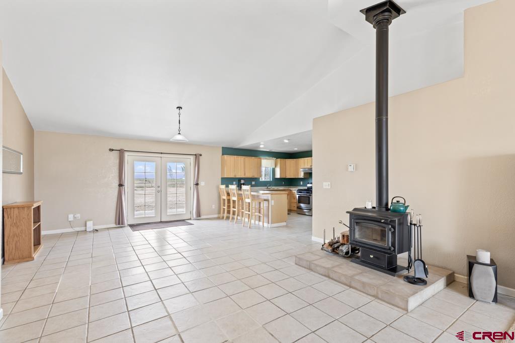 19496 E Road Delta, CO 81416 - Photo 7 of 33 a living room with furniture a fireplace and a flat screen tv