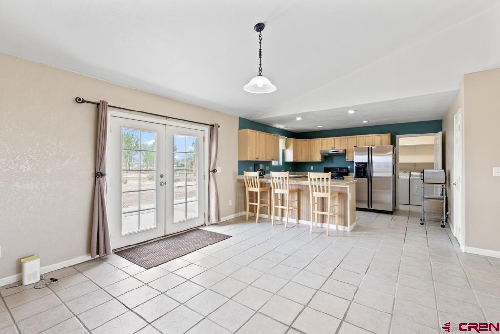 19496 E Road Delta, CO 81416 - Photo 8 of 33 a large white kitchen with a large window and kitchen view