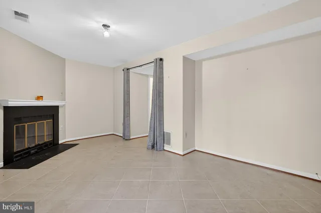 a view of empty room with a fireplace