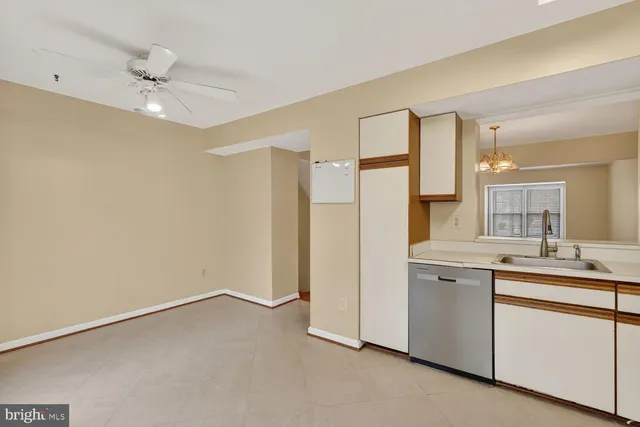 a view of a kitchen with a sink and a refrigerator