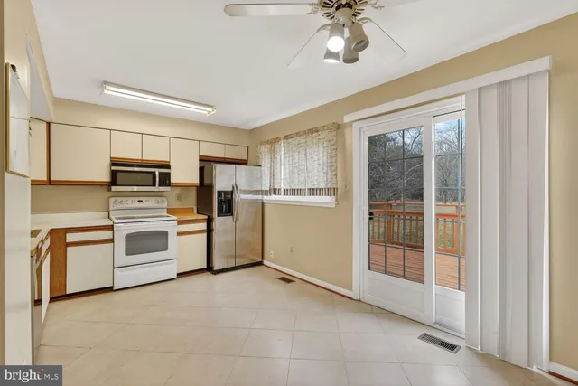a kitchen with granite countertop a stove a sink and a refrigerator