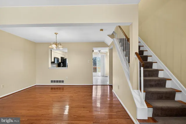 a view of a room with wooden floor and staircase
