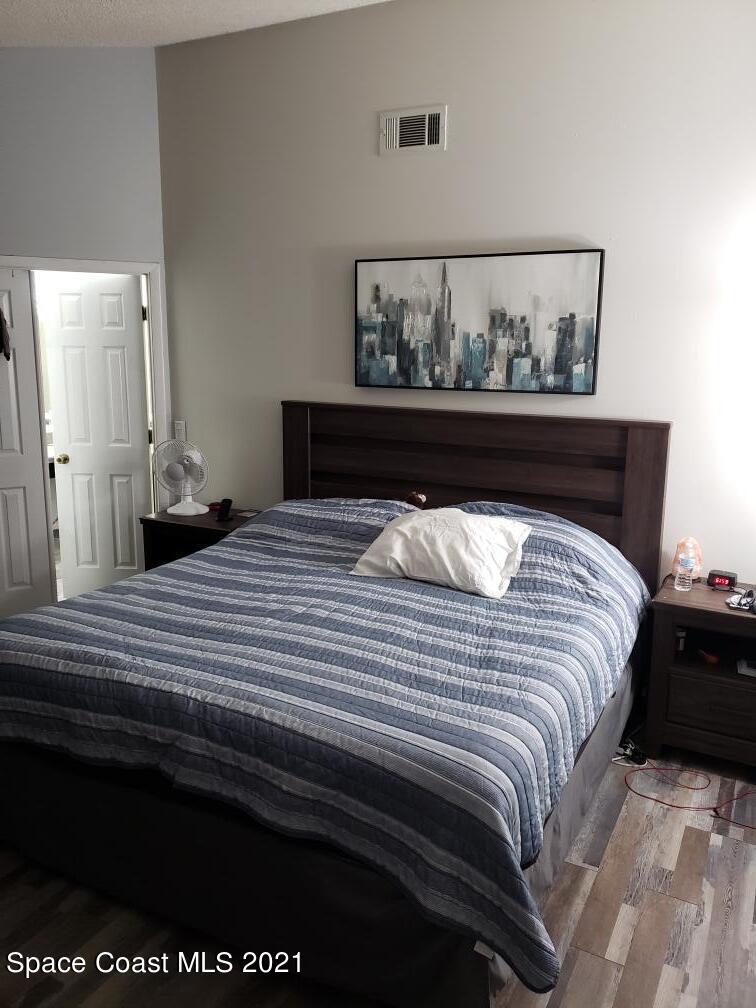 232 Rheine Road Northwest Palm Bay, FL 32907 - Photo 11 of 11 a bed sitting in a bedroom next to a cabinet