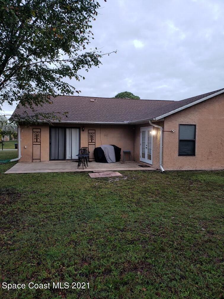 232 Rheine Road Northwest Palm Bay, FL 32907 - Photo 5 of 11 a front view of a house with a garden