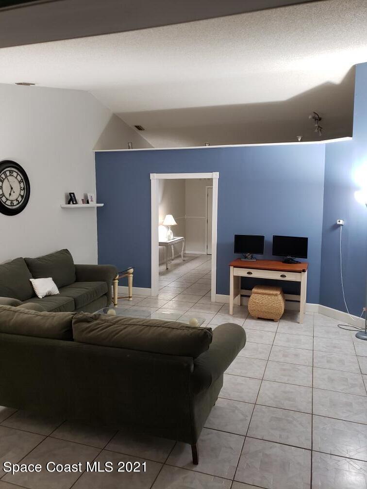 232 Rheine Road Northwest Palm Bay, FL 32907 - Photo 10 of 11 a living room with furniture and a clock