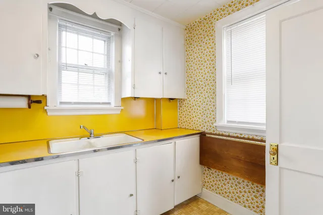 a bathroom with a granite countertop sink and a bathtub