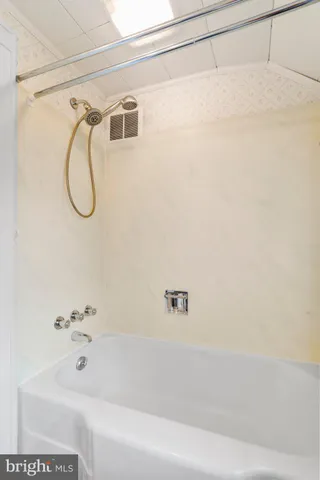 a bathroom with a tub and shower
