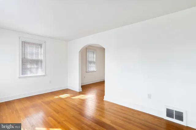 a view of a room with wooden floor and window