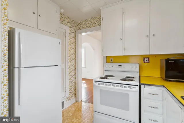 a kitchen with a refrigerator and a stove