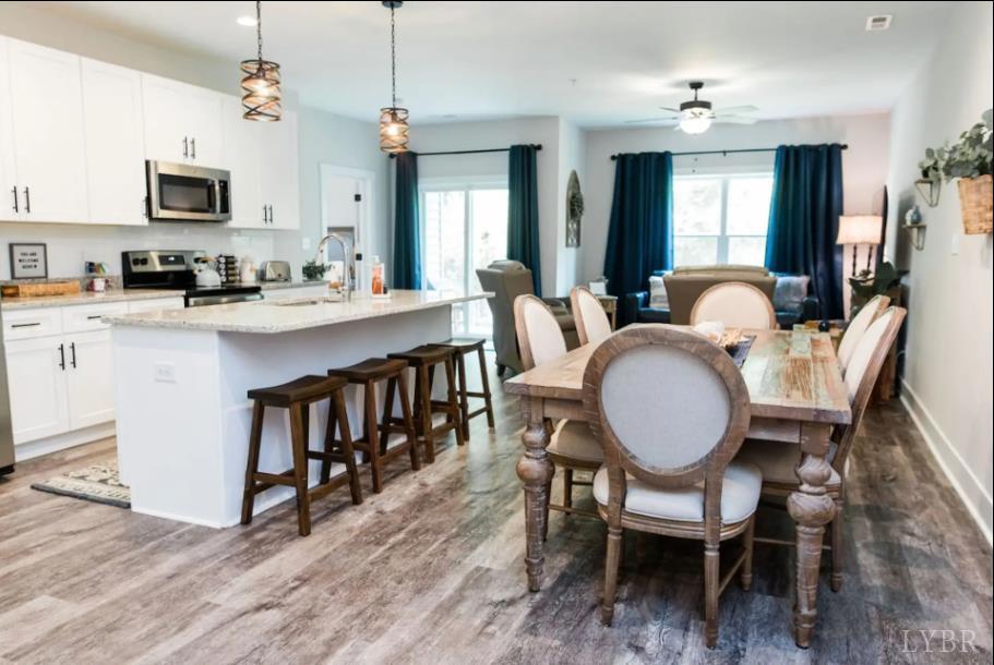1300 Stoney Ridge Boulevard, Unit 101 Forest, VA 24551 - Photo 2 of 18 a view of kitchen with sink dining table and chairs