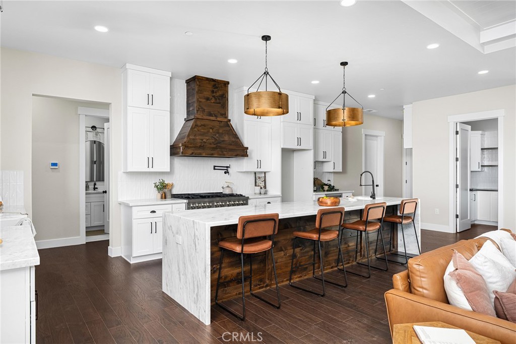 163 Valley Ridge Drive Paradise, CA 95969 - Photo 17 of 69 a kitchen with stainless steel appliances granite countertop a stove a sink a dining table and chairs with wooden floor