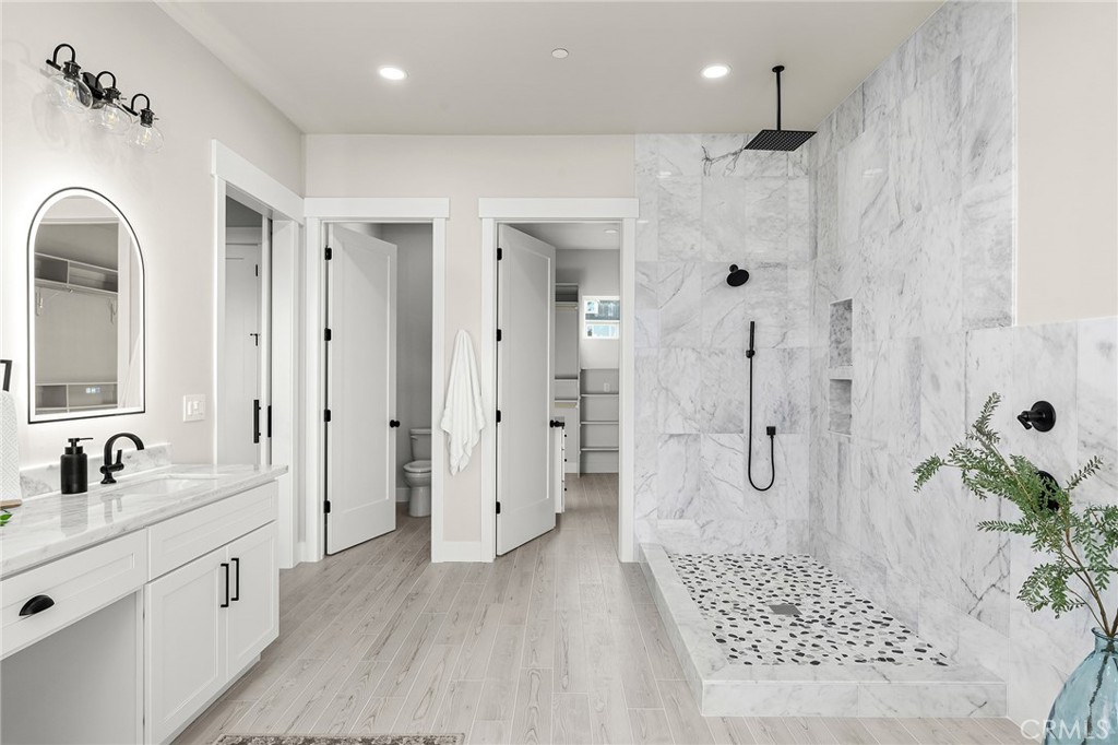 163 Valley Ridge Drive Paradise, CA 95969 - Photo 34 of 69 a spacious bathroom with a double vanity sink a large mirror and shower