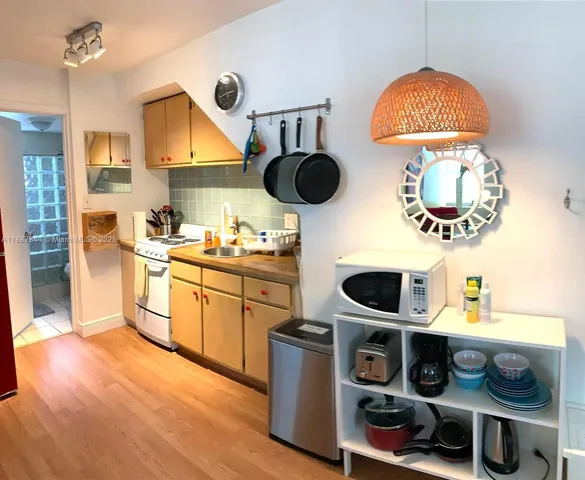 a kitchen with appliances cabinets and a table