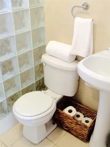 a bathroom with a toilet a sink and a mirror