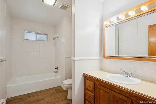 a bathroom with a sink a toilet and a bathtub