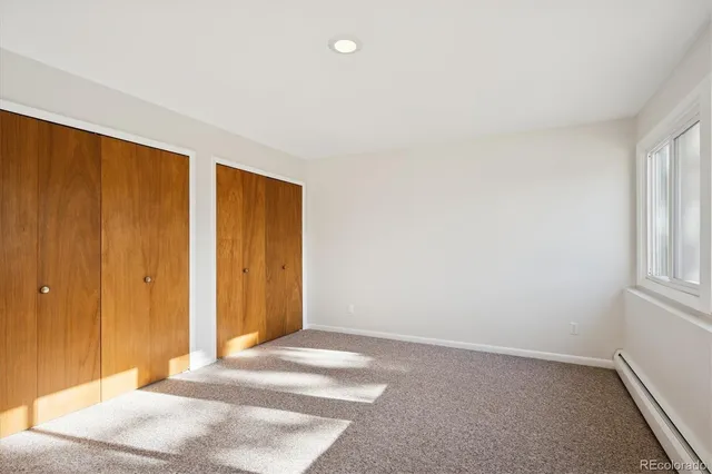 a view of a livingroom with an empty space and a window