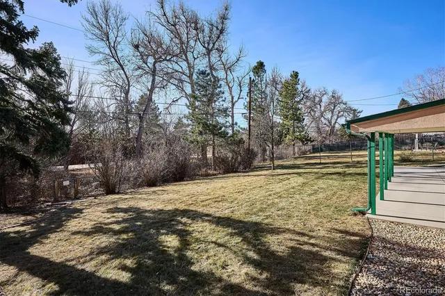 a view of yard with wooden fence