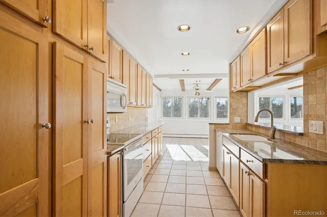 a view of a kitchen with stainless steel appliances granite countertop a refrigerator and a sink