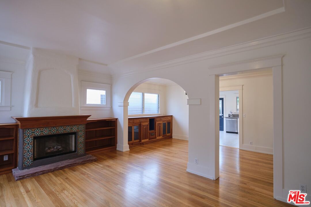 9030 Carson Street Culver City, CA 90232 - Photo 2 of 19 a view of a livingroom with a fireplace wooden floor and a window