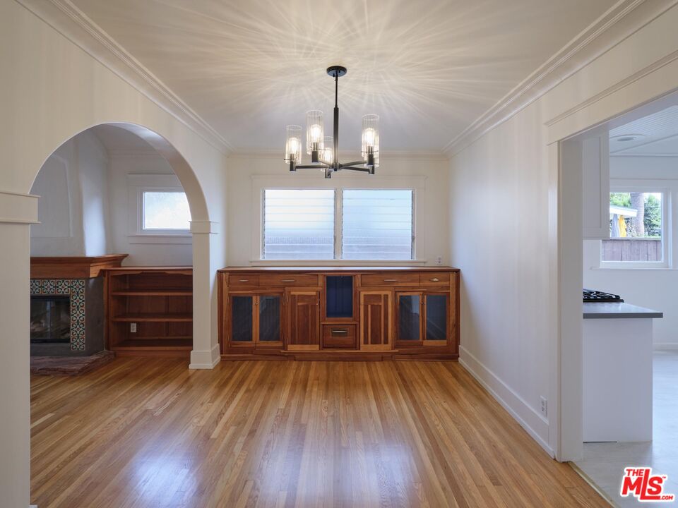 9030 Carson Street Culver City, CA 90232 - Photo 3 of 19 a view of a room with wooden floor staircase and a kitchen