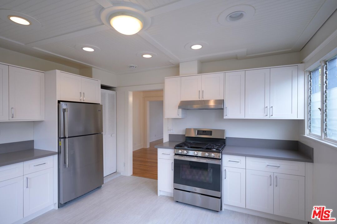 9030 Carson Street Culver City, CA 90232 - Photo 6 of 19 a kitchen with cabinets and stainless steel appliances
