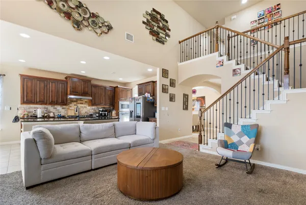 a living room with furniture and a chandelier
