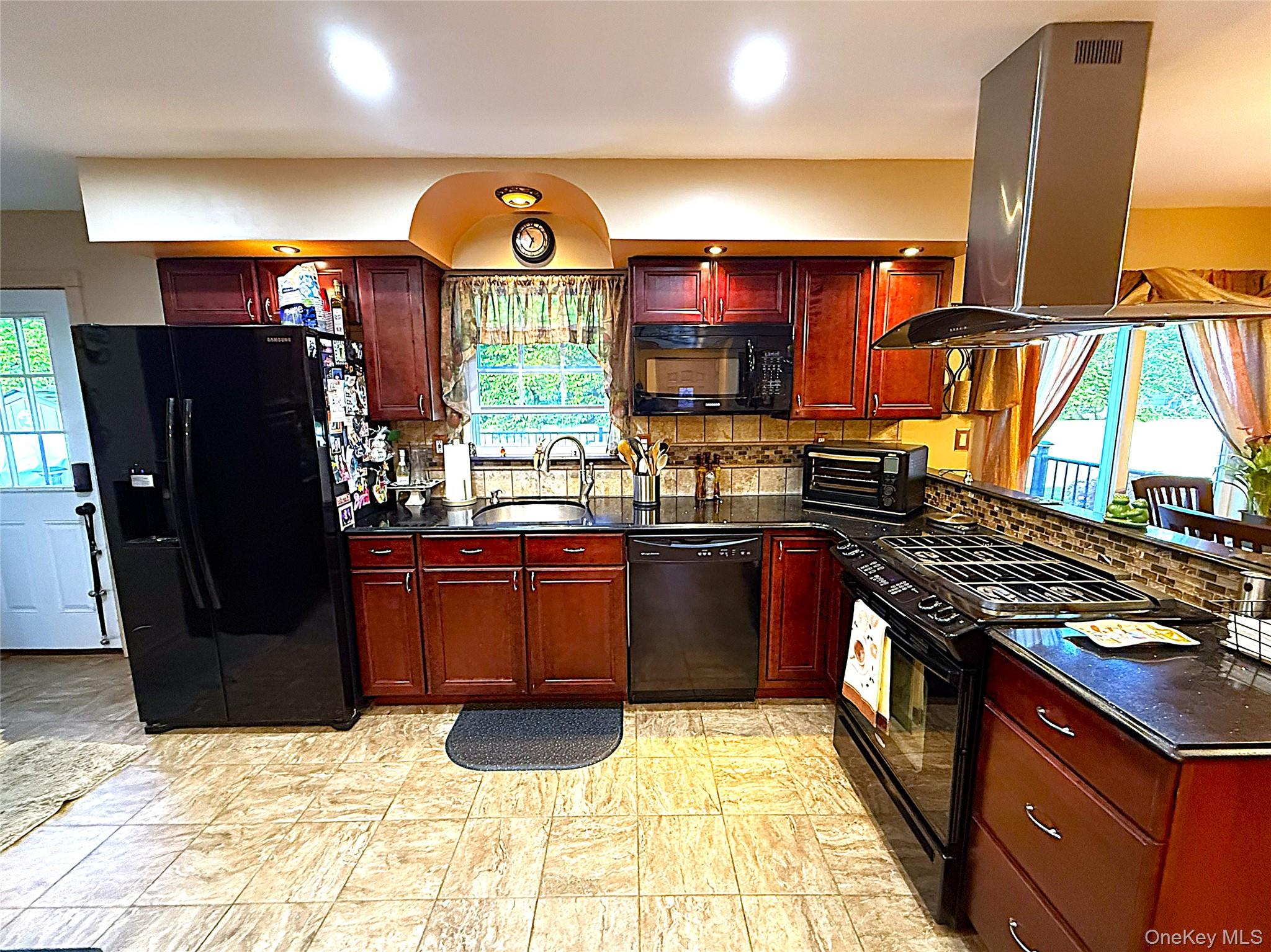 1 Heston Road Shirley, NY 11967 - Photo 14 of 32 Kitchen featuring wood-finish cabinetry and a mosaic tile backsplash