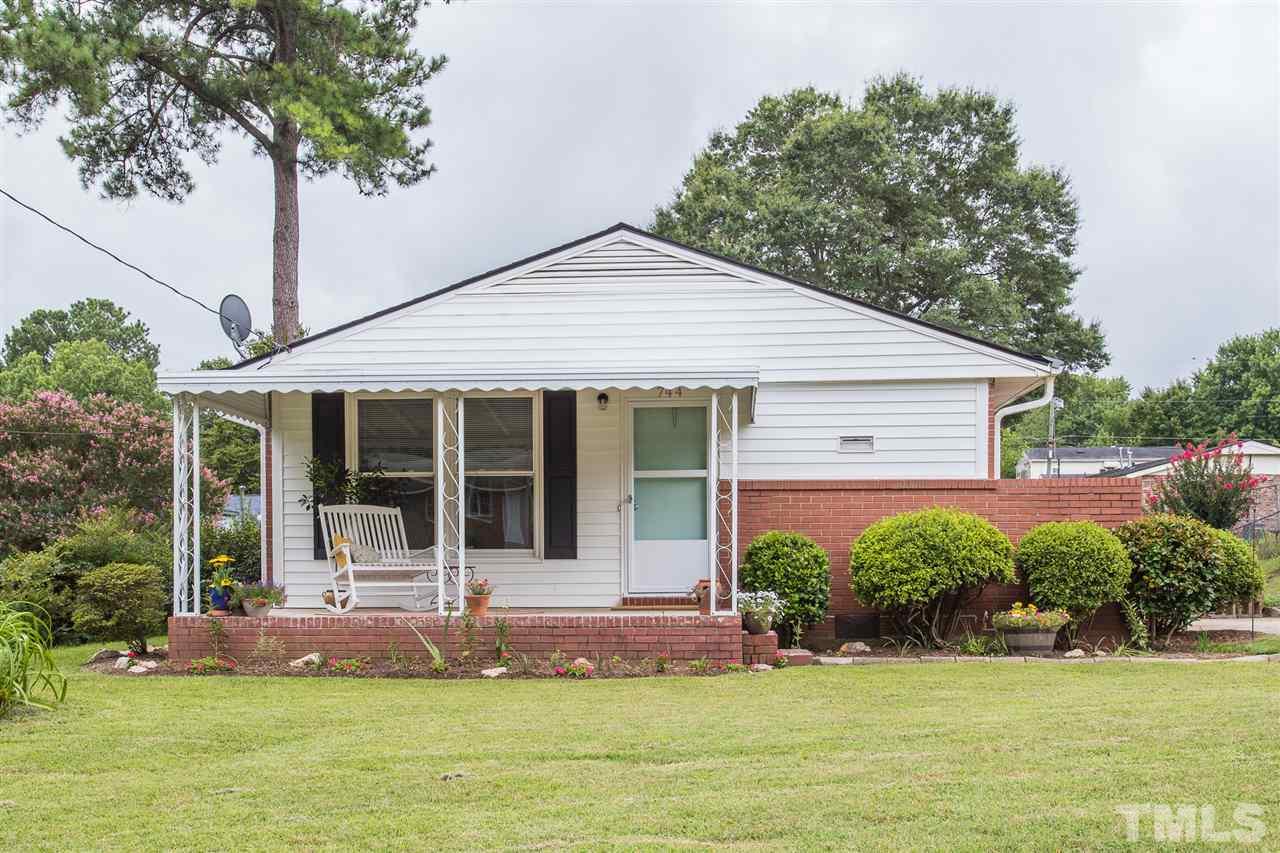 744 Fitzgerald Drive Raleigh, NC 27610 - Photo 1 of 28 a front view of a house with a garden and plants