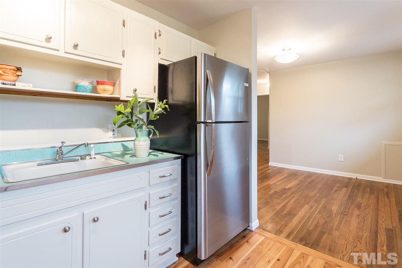 744 Fitzgerald Drive Raleigh, NC 27610 - Photo 12 of 28 a kitchen with stainless steel appliances a refrigerator and wooden floor