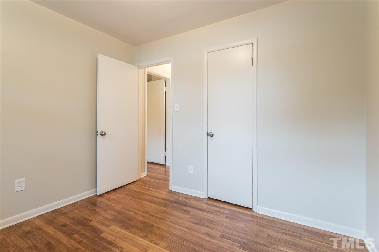 744 Fitzgerald Drive Raleigh, NC 27610 - Photo 14 of 28 a view of an empty room with wooden floor
