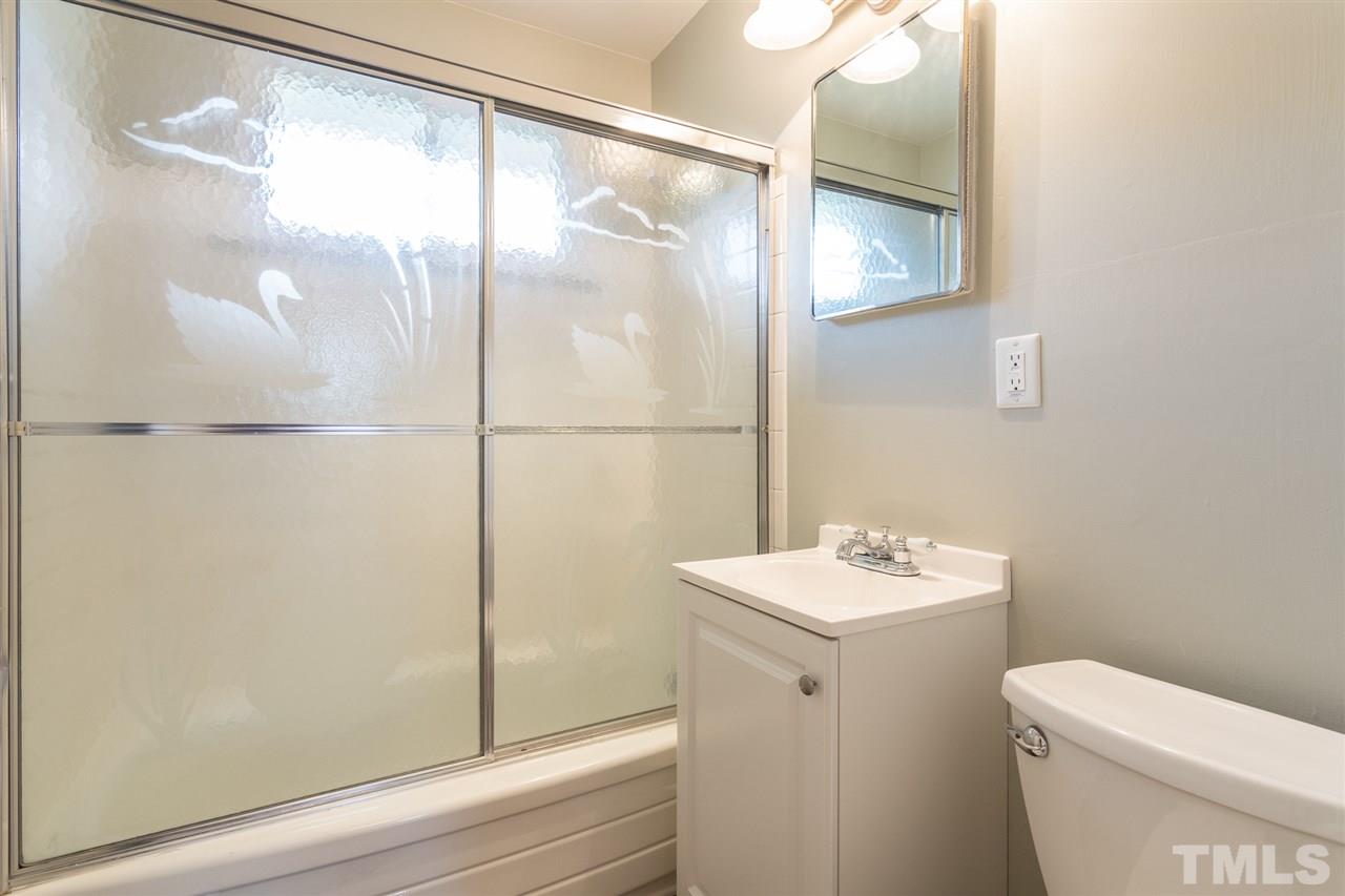 744 Fitzgerald Drive Raleigh, NC 27610 - Photo 17 of 28 a bathroom with a sink a toilet and shower