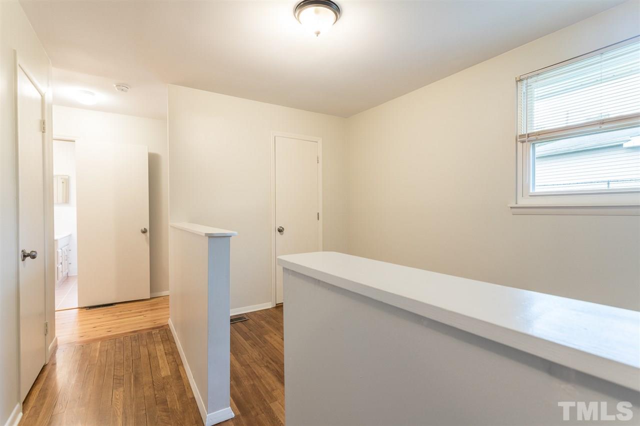 744 Fitzgerald Drive Raleigh, NC 27610 - Photo 18 of 28 a view of hallway with wooden floor