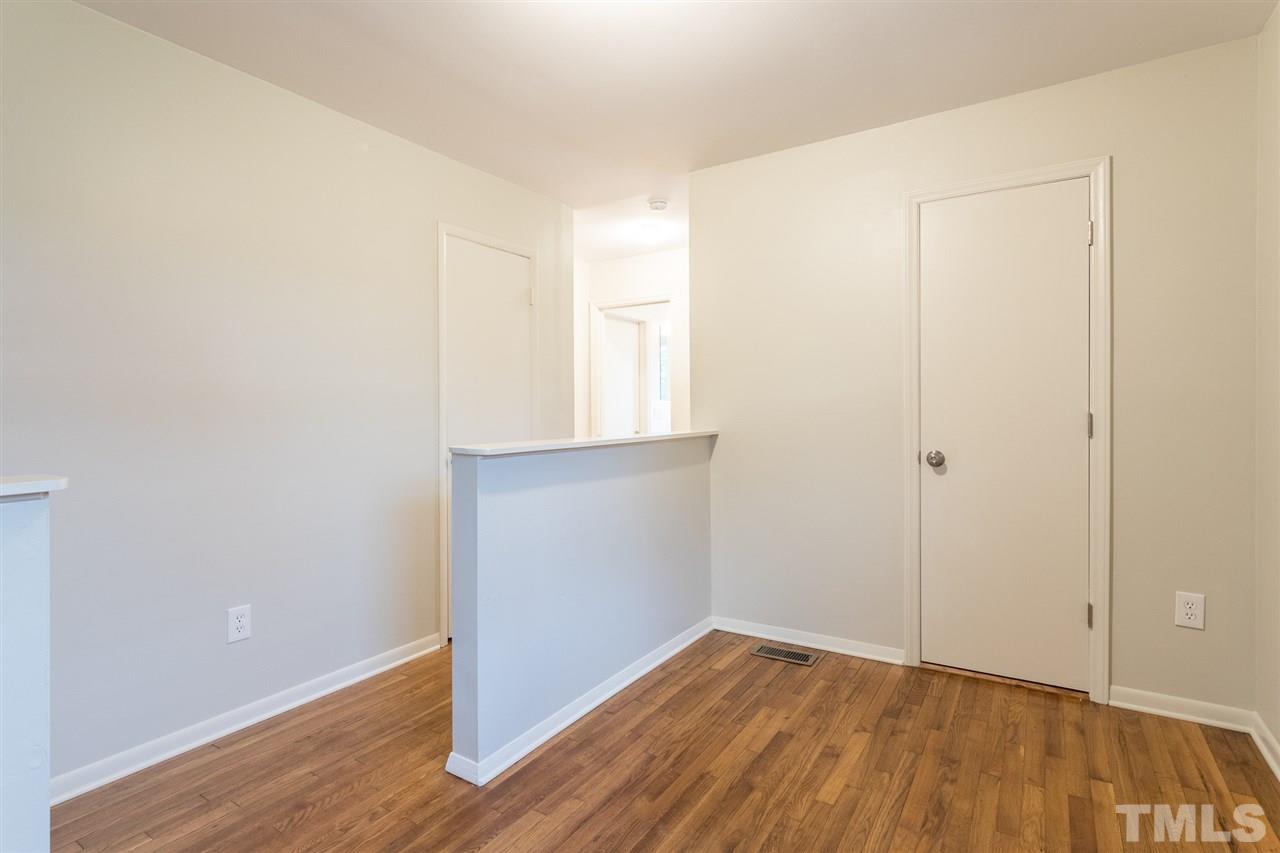 744 Fitzgerald Drive Raleigh, NC 27610 - Photo 19 of 28 a view of an empty room with wooden floor