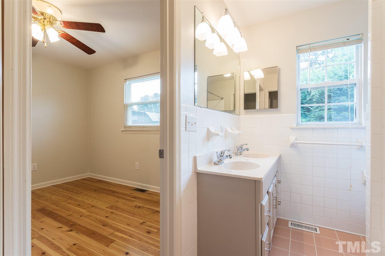 744 Fitzgerald Drive Raleigh, NC 27610 - Photo 23 of 28 a bathroom with a sink and a mirror