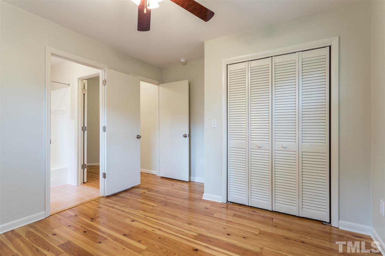 744 Fitzgerald Drive Raleigh, NC 27610 - Photo 24 of 28 an empty room with wooden floor cabinet and windows