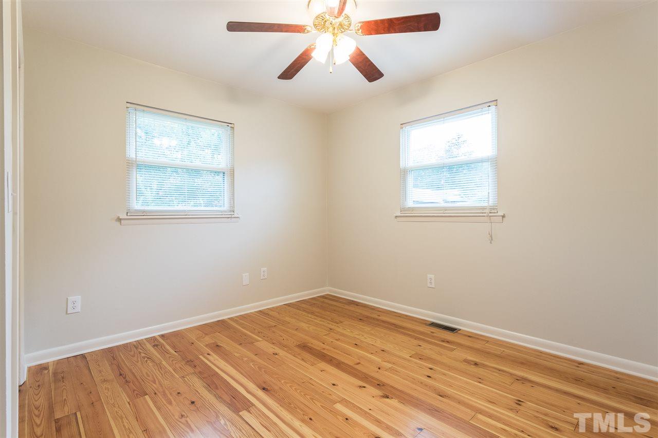 744 Fitzgerald Drive Raleigh, NC 27610 - Photo 25 of 28 a view of empty room with wooden floor