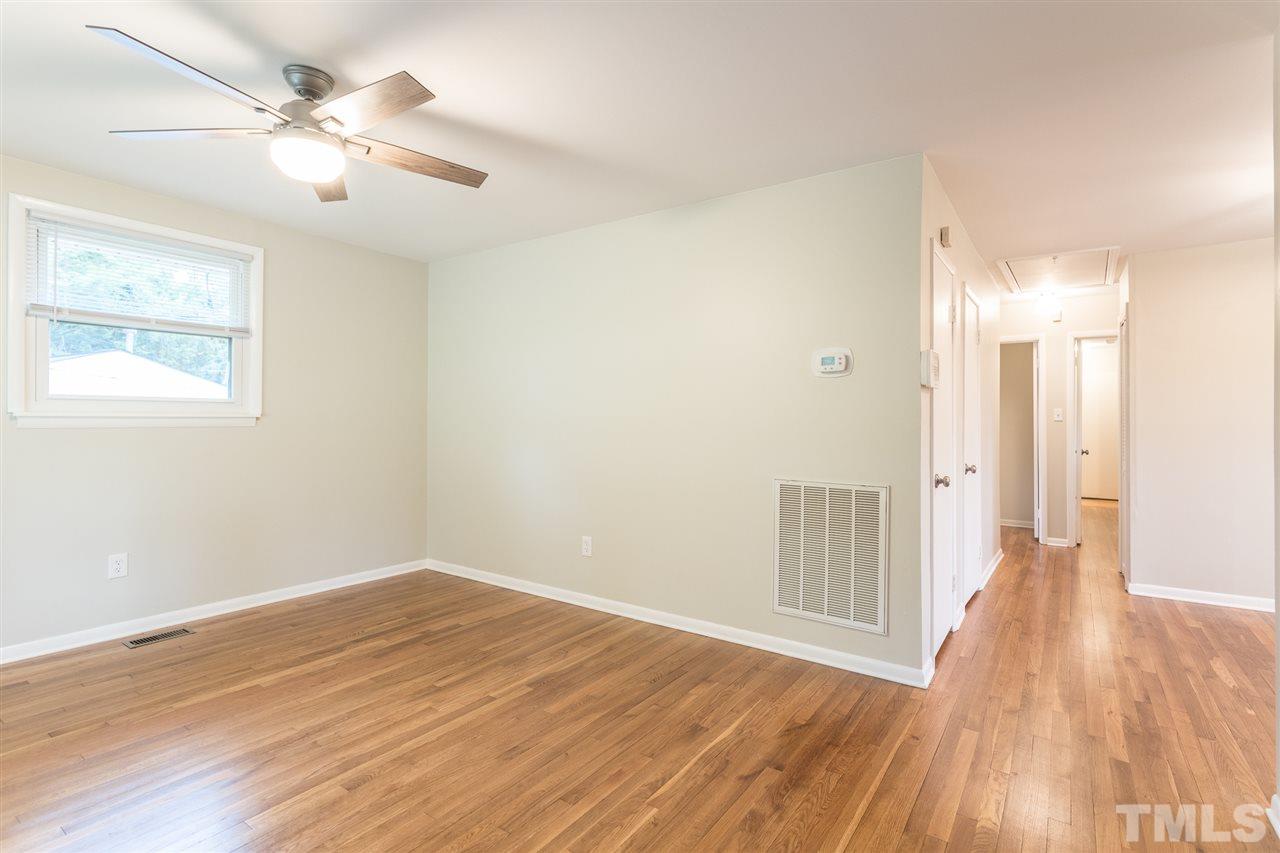 744 Fitzgerald Drive Raleigh, NC 27610 - Photo 5 of 28 a view of a room with wooden floor and a ceiling fan