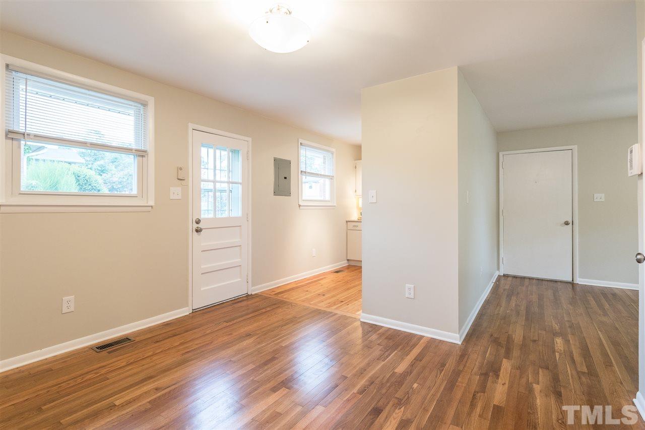 744 Fitzgerald Drive Raleigh, NC 27610 - Photo 9 of 28 an empty room with wooden floor and windows