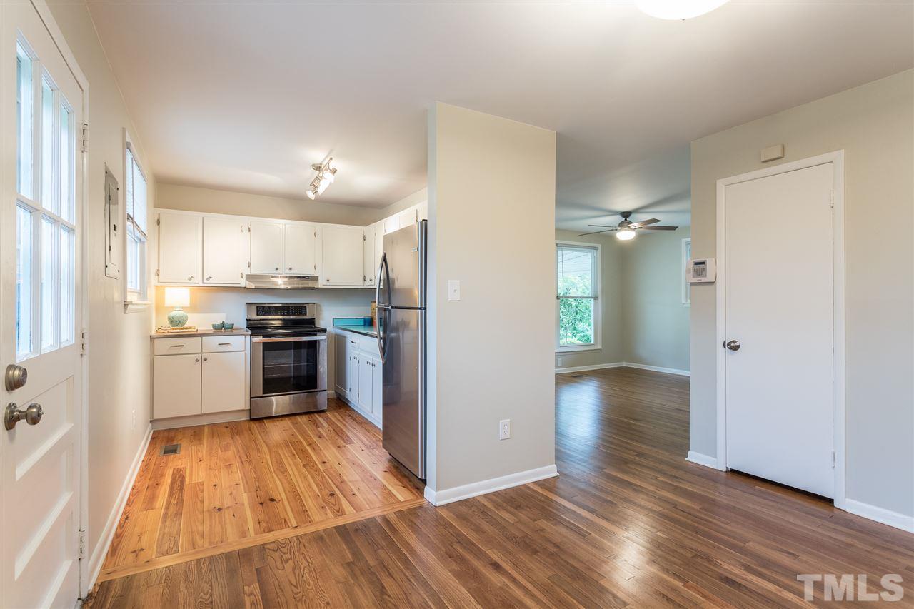 744 Fitzgerald Drive Raleigh, NC 27610 - Photo 10 of 28 a kitchen with granite countertop a refrigerator and a stove top oven