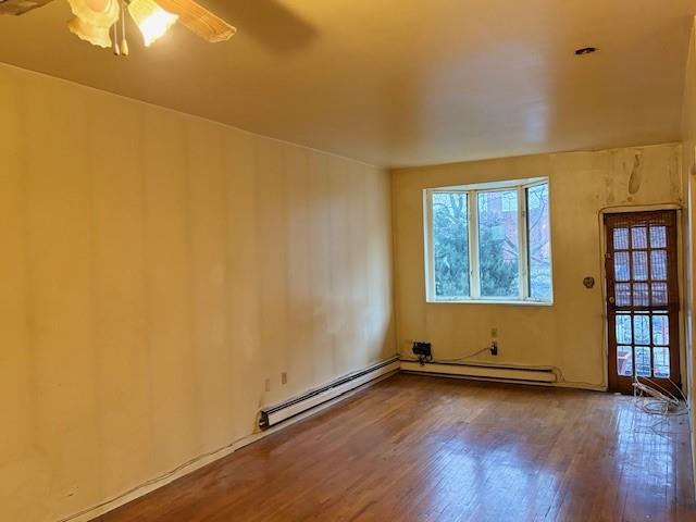 644 New York Avenue, Unit 2 Brooklyn, NY 11203 - Photo 3 of 10 an empty room with wooden floor and windows