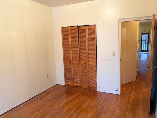 644 New York Avenue, Unit 2 Brooklyn, NY 11203 - Photo 5 of 10 an empty room with wooden floor and closet