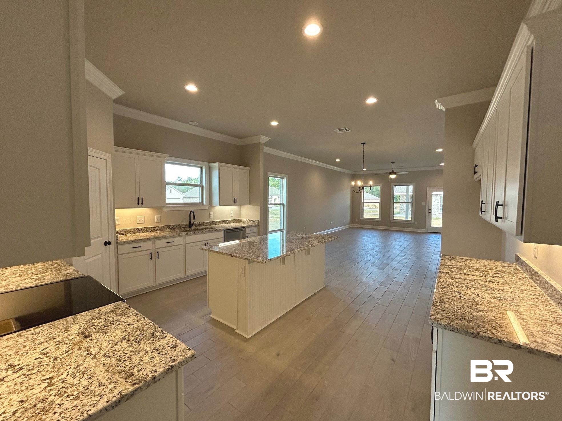 881 Sumter Loop Foley, AL 36535 - Photo 3 of 19 Kitchen with white cabinetry, a kitchen island, a healthy amount of sunlight, and ceiling fan